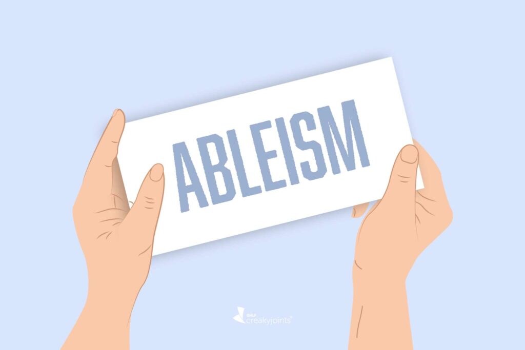 An illustration of two hands holding a sign with the text "ableism" in large capital letters against a light background