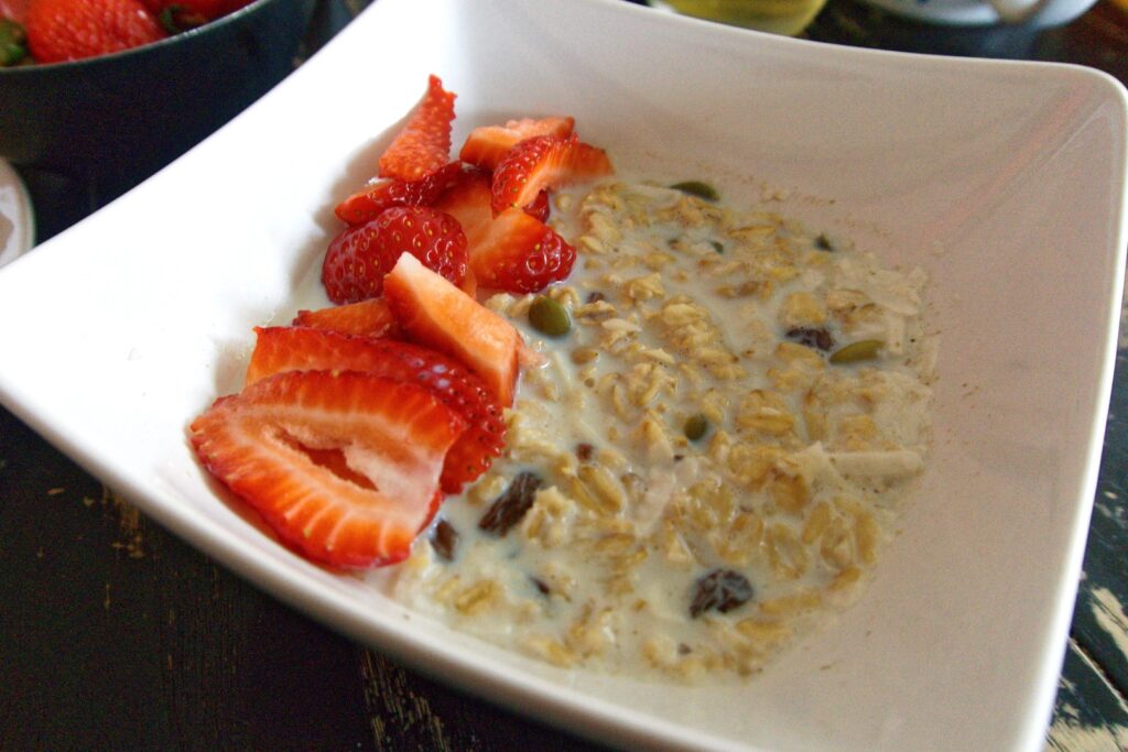 a bowl of overnight pats with fresh strawberries