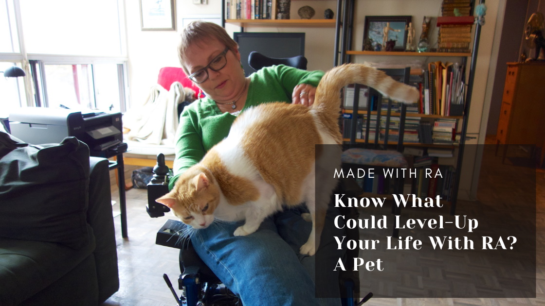 "During a time when I was isolated and depressed due to illness, my cat gave me love, at least one daily laugh and a reason to get up." How pets can make our lives better with Chronic Illness and tips on what to consider before you adopt. Photo of a white woman with short hair and glasses sitting in a wheelchair with a white and orange tabby on her lap.