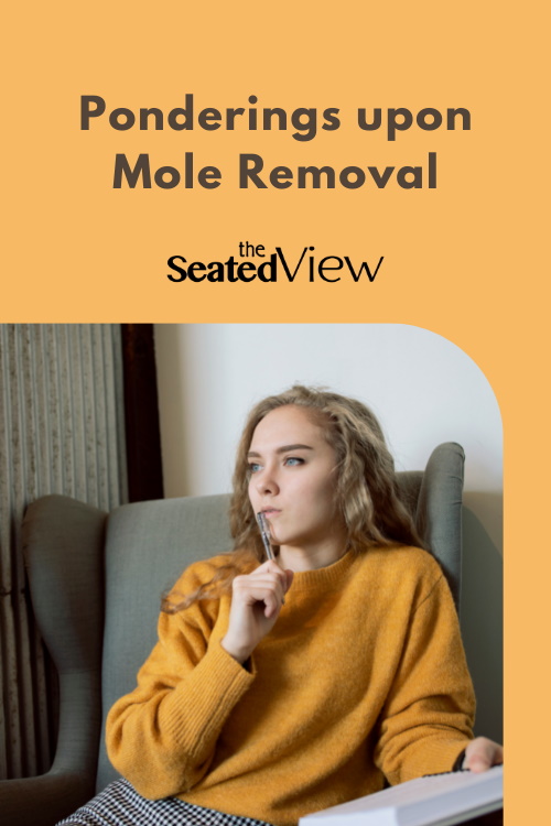 Ponderings about Mole Removal, a record of silly and meaningful thoughts while getting a mole removed. Pinterest graphic, yellow background, photo of a woman with a yellow sweater thinking in a grey chair