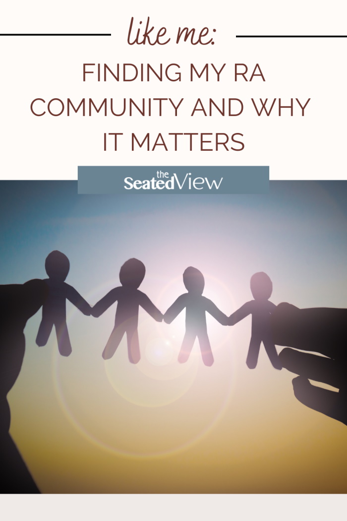 Cut out of the four little paper figures holding hands held by someone hands holding them up against the sun. Interest Graphic: "Like Me: Finding My RA Community and Why It Matters." Logo for The Seated View